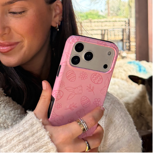 Girl holding lamb and blush bunny tough phone case in hand