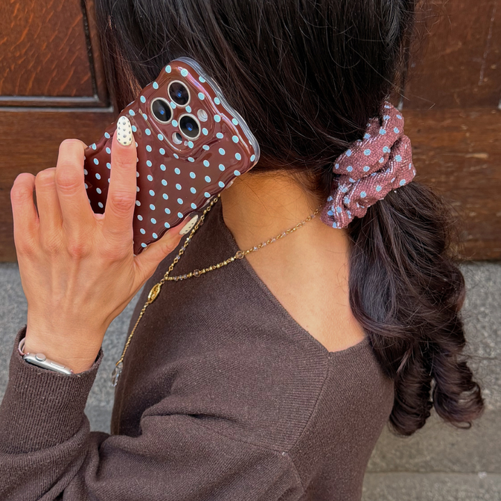 Girl wearing brown and blue scrunchie in hair