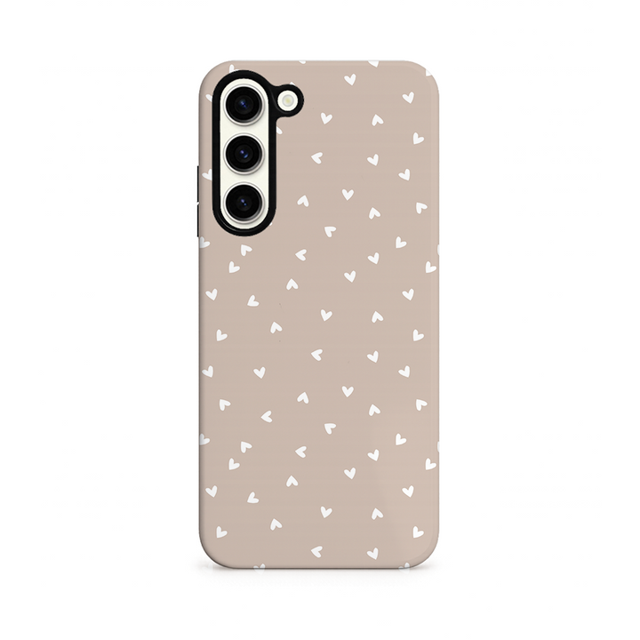 Beige phone case with white heart pattern on white background 