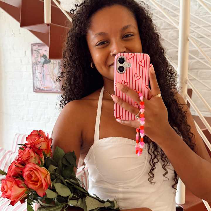 Girl with hearts phone strap