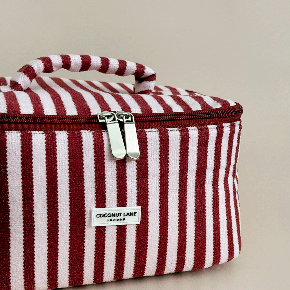 Burgundy and light pink striped Vanity Case, with handle, silver zip and Coconut Lane logo badge.