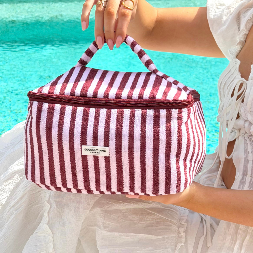 Close up of the Blushberry Scallop Stripes Vanity Case next to the pool