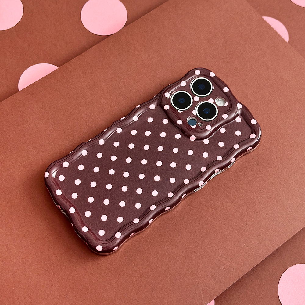 Coconut Lane wavy phone case with white dots on a pink and brown background.