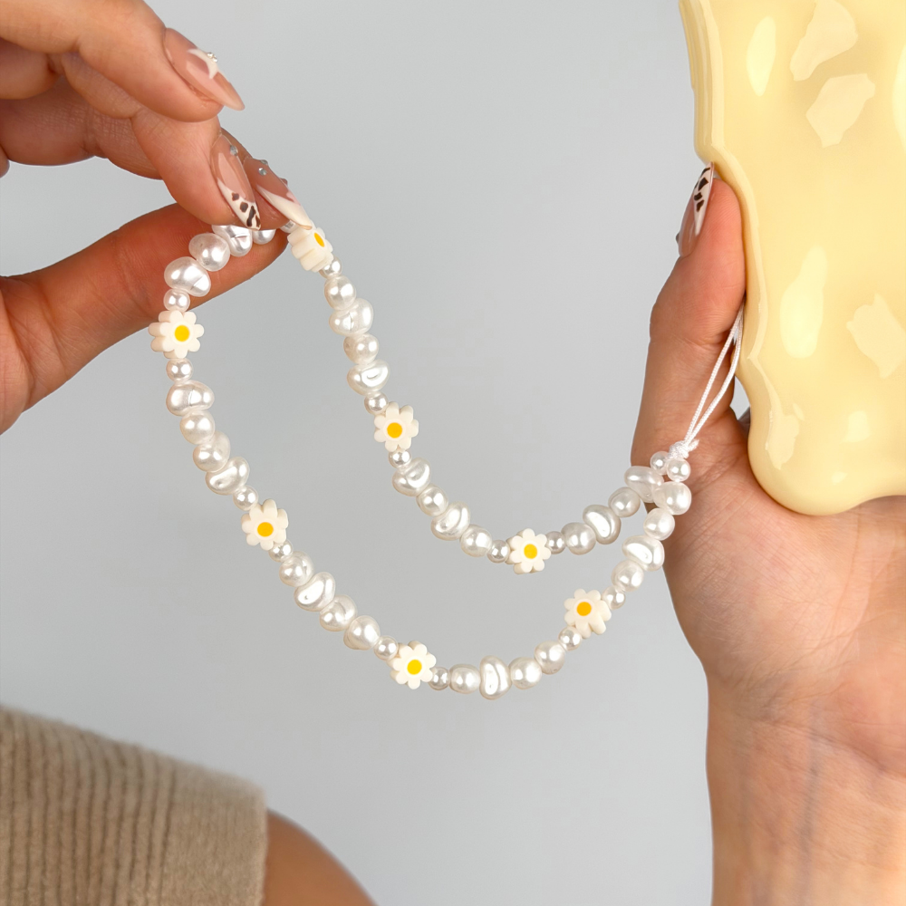 close up of daisy pearl phone strap