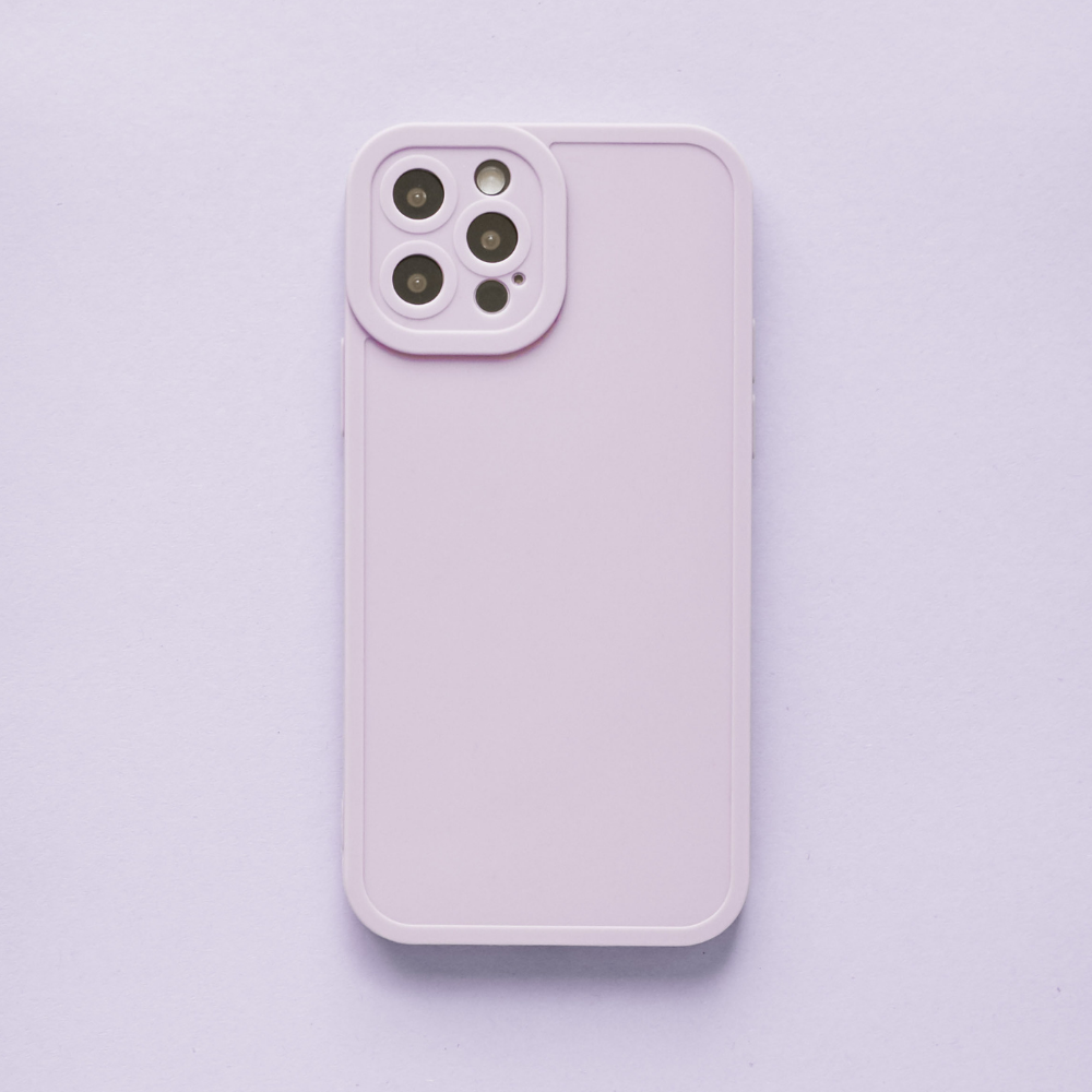 A lilac NAKD phone case from Coconut Lane's spring collection is showcased from the back against a matching background. The case features full camera protection for a quad camera setup located at the top left corner. Its sleek and minimalistic design makes it one of this season's pastel favorites.